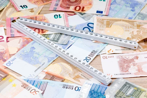 Ruler on a layer of bank notes
