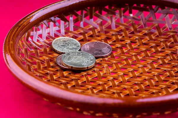 A pot on its side with a few coins, a concept of a tight budget