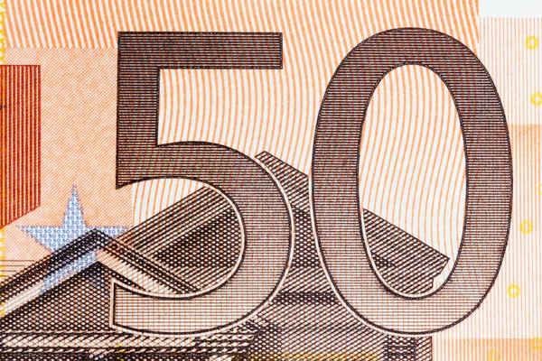 Macro shot of a fifty euro bill showing the number fifty with its texture