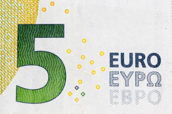 Macro shot of a five euro bill showing the number five with its texture