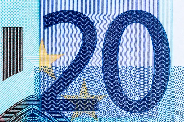 Macro shot of a twenty euro bill showing the number twenty with its texture