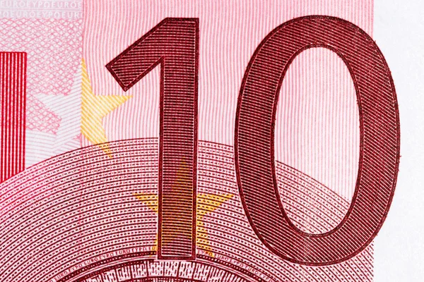 Macro shot of a ten euro bill showing the number ten with its texture