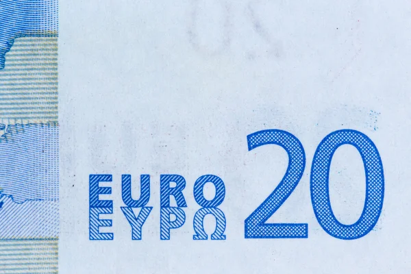 Macro shot of a twenty euro bill showing the words twenty euro