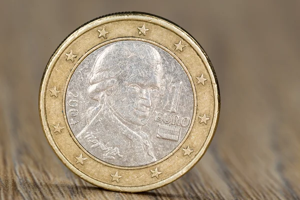 Close up of a one euro coin from the European Union member Austria showing the portrait of Wolfgang Amadeus Mozart, a famous Austrian composer