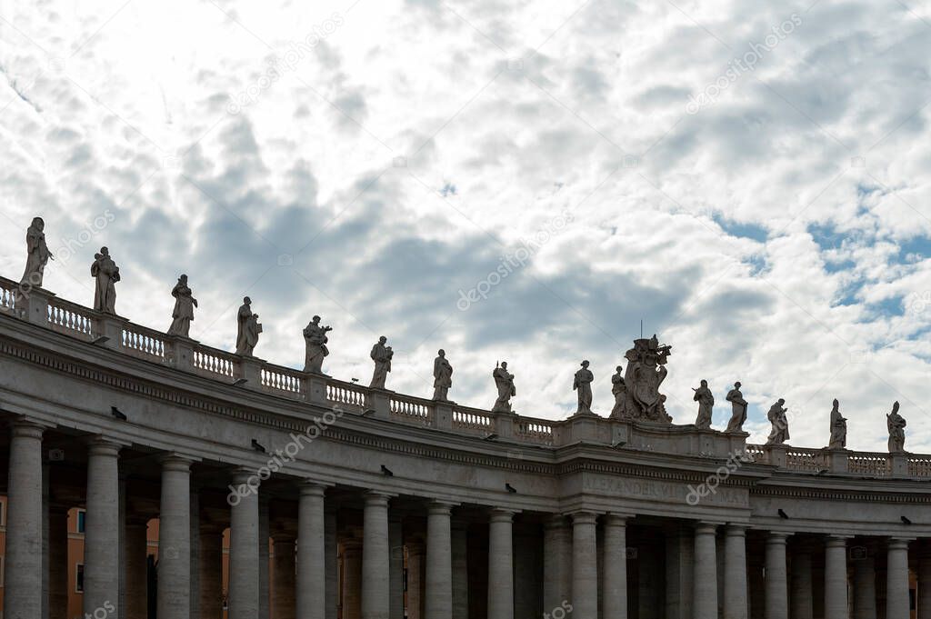 Details of the entablature with statues of religious saints on the colonnades of St. Peter's Basilica at St. Peter's Square in Vatican City, Rome, Italy