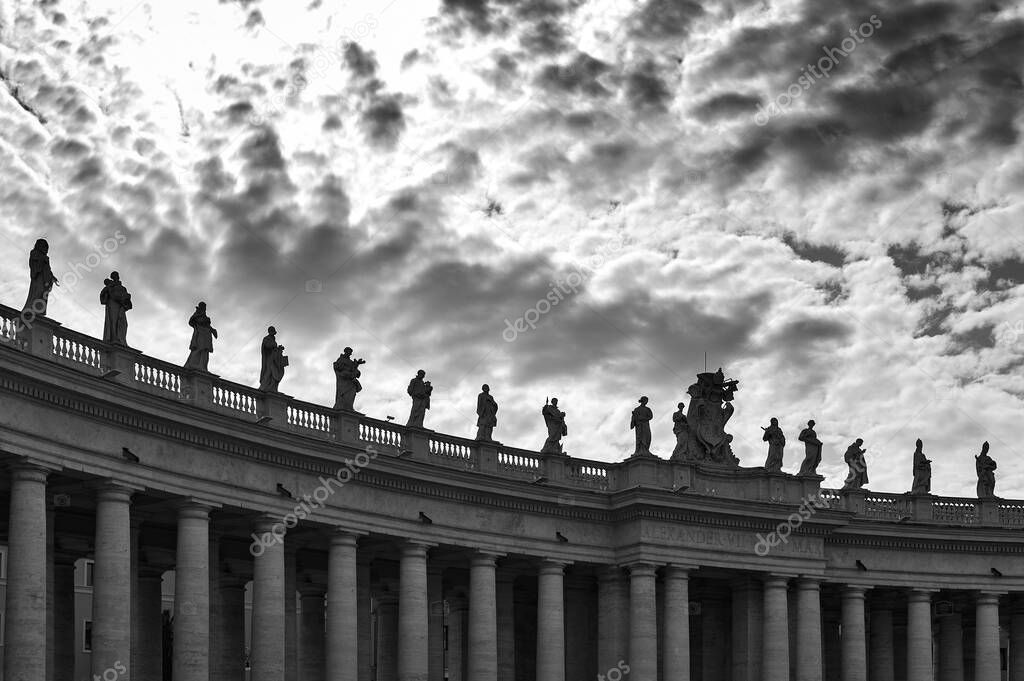 Details of the entablature with statues of religious saints on the colonnades of St. Peter's Basilica at St. Peter's Square in Vatican City, Rome, Italy
