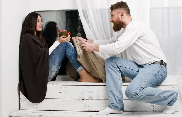 Man hides a woman leg leather brown plaid