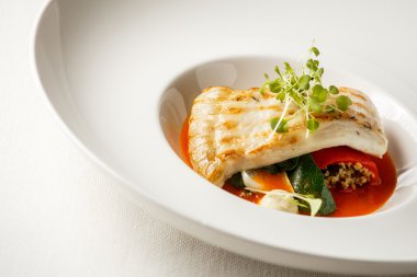 Grilled turbot, tabouli, sweet pepper sauce and summer vegetables. White dish clipart