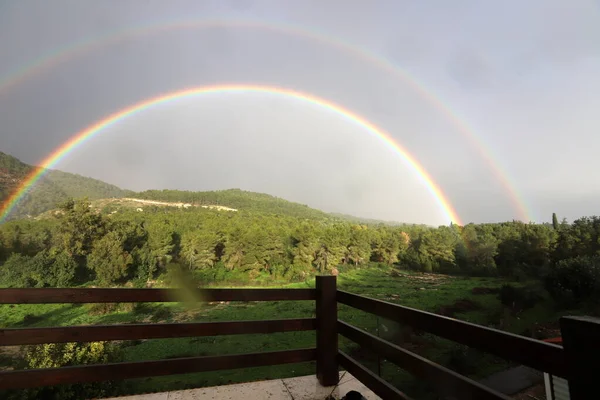 double rainbow in the mountains above the forest after rain in northern Israel