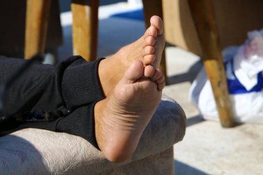 legs of an athlete running barefoot on a sandy beach in sea water. Vacation, travel and adventure concept 