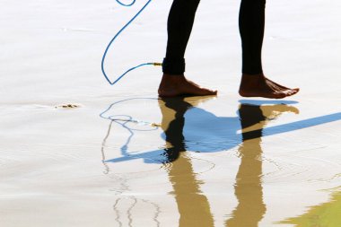 legs of an athlete running barefoot on a sandy beach in sea water. Vacation, travel and adventure concept 