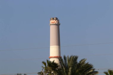 Mavi gökyüzüne karşı şömine kutusundaki hava akımını arttırmak için yüksek baca 