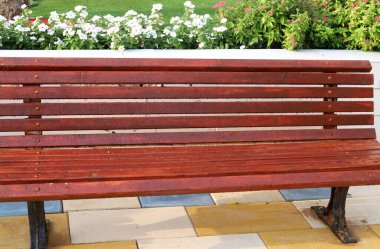 A bench for relaxation stands in a city park on the shores of the Mediterranean Sea on the Sesere of Israel 
