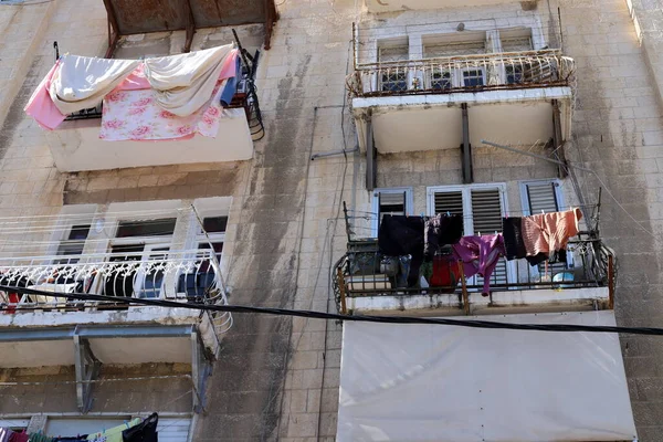 The washed clothes are dried on a clothesline outside the apartment window. The traditional way of drying clothes in Israel