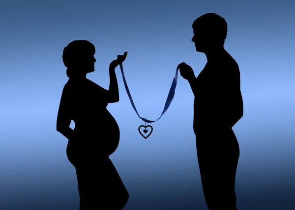 Silhouette of a young couple expecting a baby — Stock Photo, Image