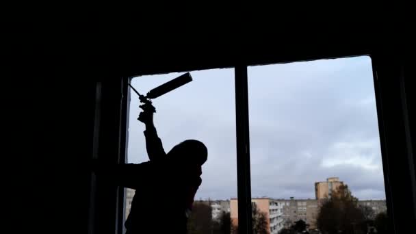 Silhouettes of a builder foaming a wall for installing windows. — Stock Footage Silhouettes of a builder foaming a wall for installing windows. Stock Video