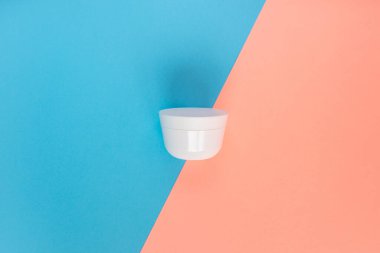 Sıvı, krem, jöle ve losyon için kavanoz. Mavi ve gül arkaplanlı osmetik kavanoz. SPA kozmetik ürünleri markalaştırma modeli. Minimalist tarzda dümdüz yatıyordu. Düz yatış minimalist tarzı.