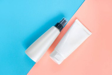 Sıvı, krem, jöle ve losyon için makyaj seti. Mavi ve gül arkaplanlı osmetik şişe. SPA kozmetik ürünleri markalaştırma modeli. Düz yatış minimalist tarzı.