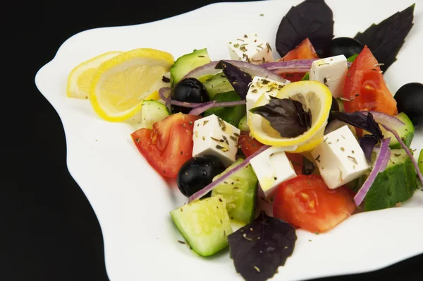 Greek salad in the white plate — Stock Photo, Image