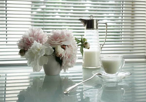 Summer Still Life with Jug, cup and peonies on a glass table — Stok Foto