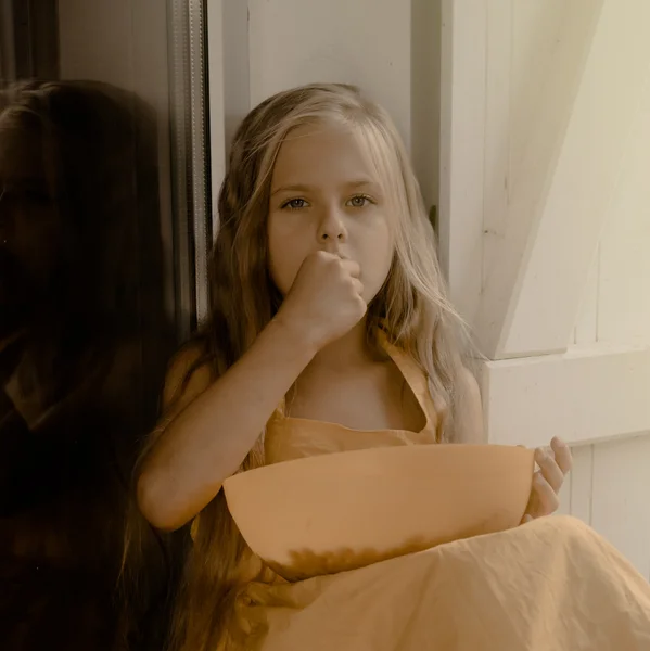 Vintage. dziewczyna siedzi na tarasie okna i zjada jagody w żółtej sukience. styl retro — Zdjęcie stockowe