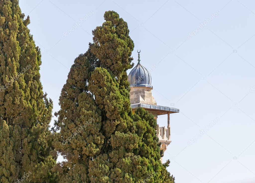 The top of the Minaret over the Islamic Museum is visible behind the trees on the Temple Mount in the Old Town of Jerusalem in Israel