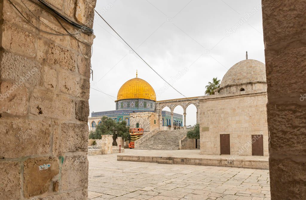 View of the Dome of the Rock mosque and the Grammar Dome - Office of Chief Judge between the columns of the tunnel running along the western wall on the Temple Mount, in the old city of Jerusalem, in Israel