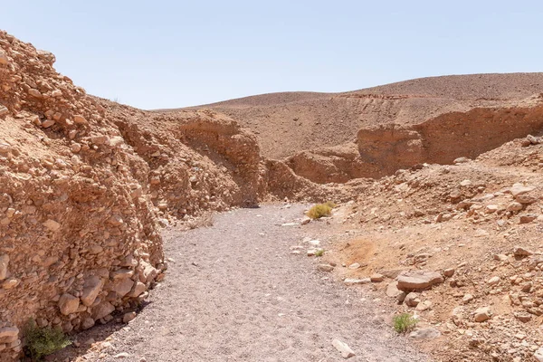 A path along a dry riverbed to a nature reserve near Eilat city - Red Canyon, in southern Israel