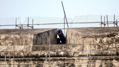 An ancient cast cannon is located on the old city fortress wall in Florianna in Malta