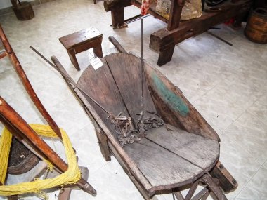 Rhodes, Greece, July 05, 2011 : Wooden wheelbarrow with agricultural tools as exhibits at Agricultural Museum of Rhodes on Rhodes island in Greece