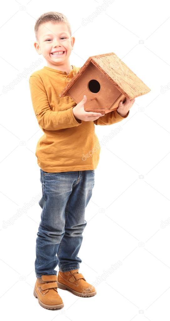 Boy holding wooden birdhouse