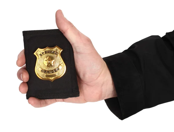 Man handen med gyllene särskilda officer badge — Stockfoto