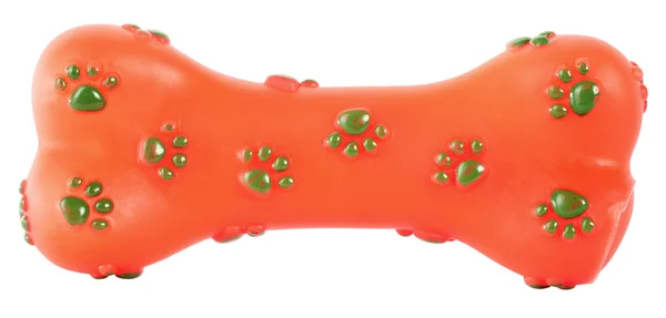 Knochen-Gummispielzeug für Hunde orange mit grünen Pfoten — Stockfoto