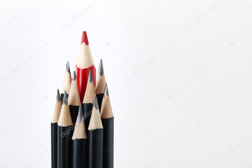 Black pencils with a red one in the middle