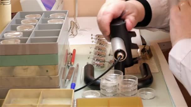 SAINT-PETERSBURG, RUSSIA-December 29, 2014, the old factory for the production of watches "The Rocket", Foreman in a white coat working on checking mechanism assembled watches — Stock Video