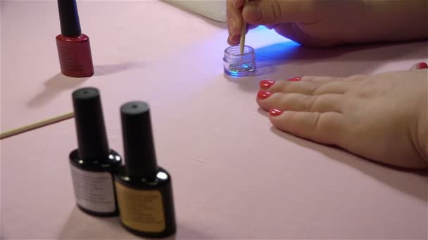 Fixing Swarovski crystals on nail manicure using sticks — Stock Video