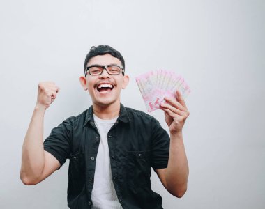 Mutlu bir birey zenginliği banknotlarla kutluyor, heyecan saçıyor..