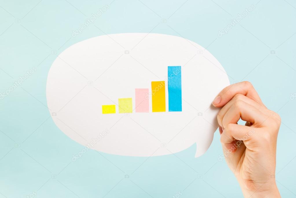 Hand holding speech bubble with a bar graph growing up. Metrics, measures, analytics concept.