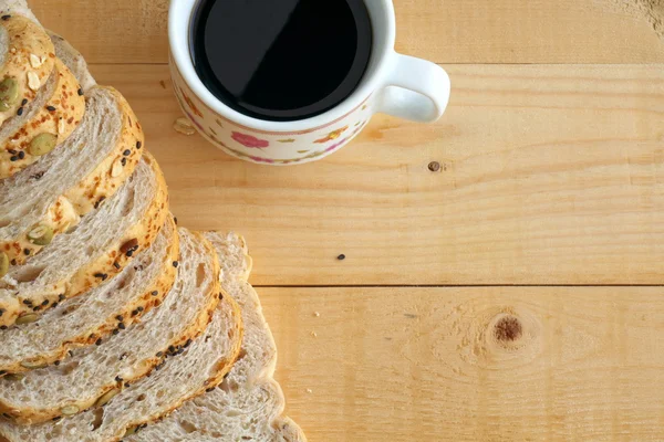 Flat lay of whole wheat bread and and coffee on wooden table.copy space — Stock Photo, Image