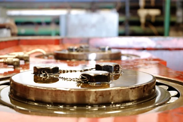 Close up of bolts safety wired together on a retaining plate for a bearing. — Stock Photo, Image