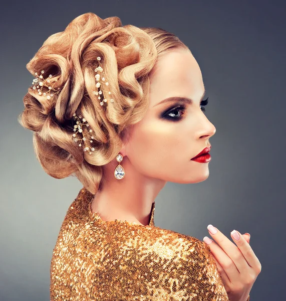 Blond woman in golden dress — Stock Photo, Image