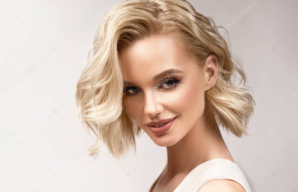 Beautiful girl with hair coloring in  blond. Stylish hairstyle curls done in a beauty salon. Fashion, cosmetics and makeup