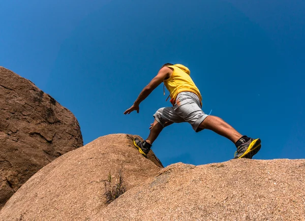 Wanderer springt über den Felsen — Stockfoto