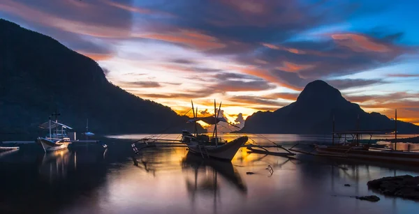 Trópusi színes naplementét a banca csónakokkal El Nido, Palawan, Fülöp-szigetek — Stock Fotó