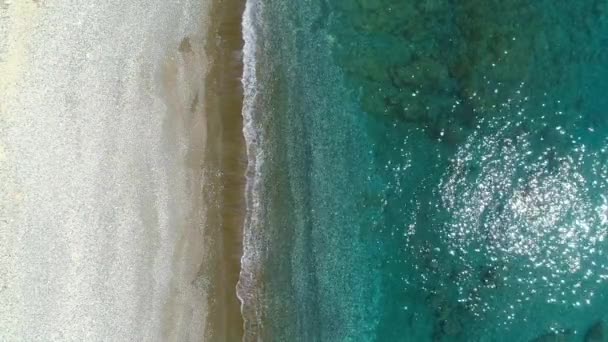 Vista aerea, giornata di sole sul mare o sull'oceano. Vacanza e relax in un luogo appartato. Estate giorno paesaggio marino. Spiaggia del Mar Mediterraneo. Struttura dell'acqua chiara. Vista dall'alto in 4K — Video Stock