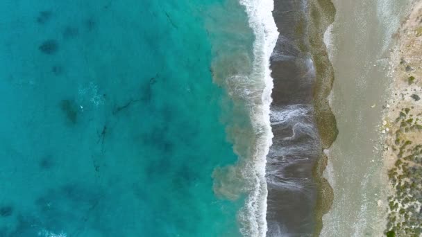 Aerial view, sunny day over sea or ocean. Vacation and relax in a secluded place. Summer day seascape. Mediterranean sea beach. Clear Water texture. Top view in 4K — Stock Video