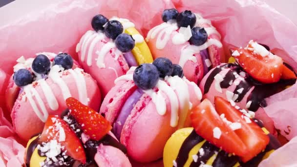 Handmade Beautiful Macaroon, Sweet food, Dessert with fresh strawberries and blueberries decorated with chocolate, Delicate yellow and pink cakes, Sugar and healthy food — Stock Video