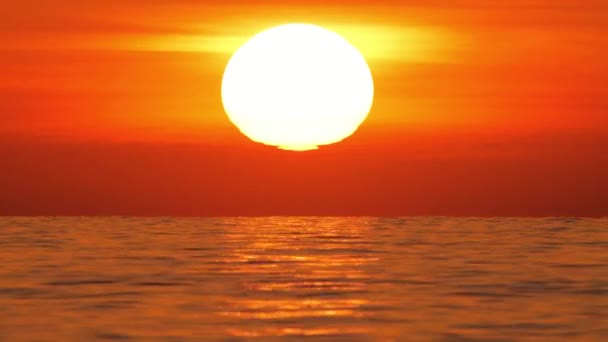 Big Red Hot Sun in Warm Air Distortion Above Ocean Horizon, Sunset over the sea, Big Rising Sun with Clouds. Closeup Telephoto Lens. Travel, Beginning, Nature Concept — Stock Video