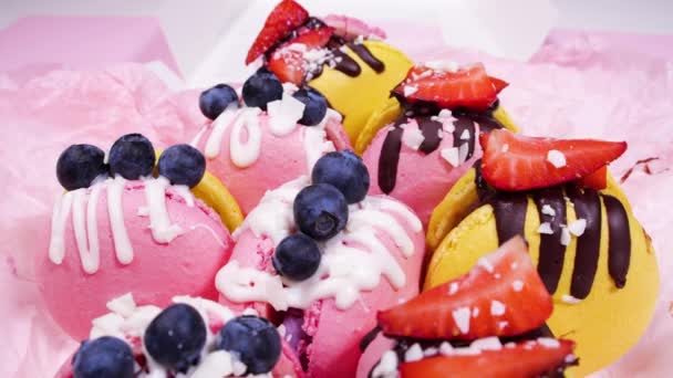 Macaroon, Handmade Beautiful Sweet food, Dessert with fresh strawberries and blueberries decorated with chocolate, Delicate yellow and pink cakes, Sugar and healthy food — Stock Video