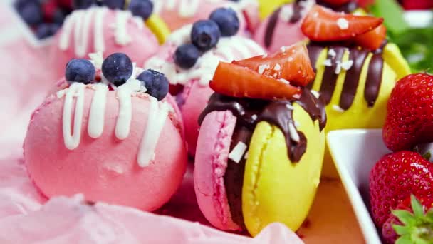 Macaroon Handmade Beautiful Sweet food, Dessert with fresh strawberries and blueberries decorated with chocolate, Delicate yellow and pink cakes, Sugar and healthy food — Stock Video